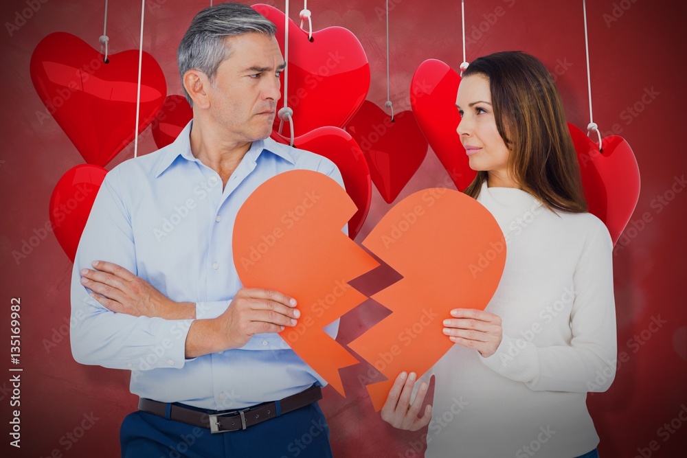 Composite image of couple holding broken heart shape paper 3d