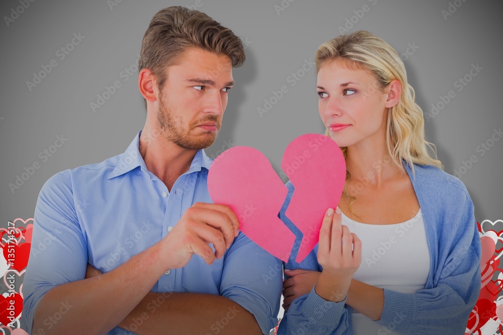 Composite image of couple holding two halves of broken heart