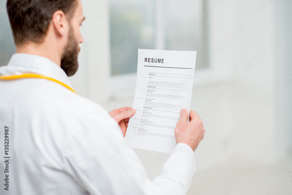 Doctor reading resume for job hiring in the hospital