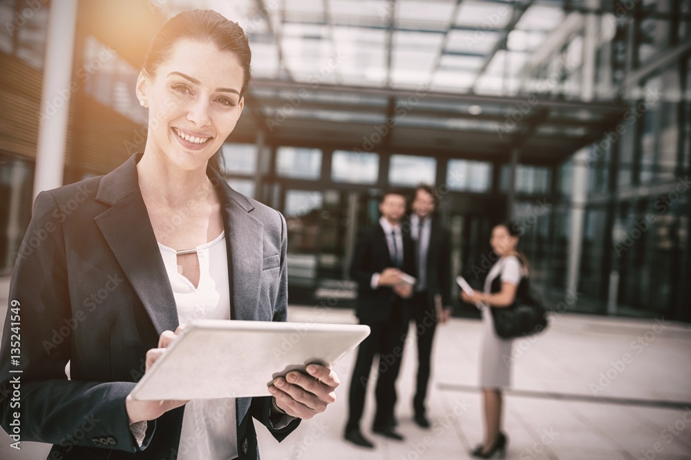 Portrait of businesswoman holding digital tablet