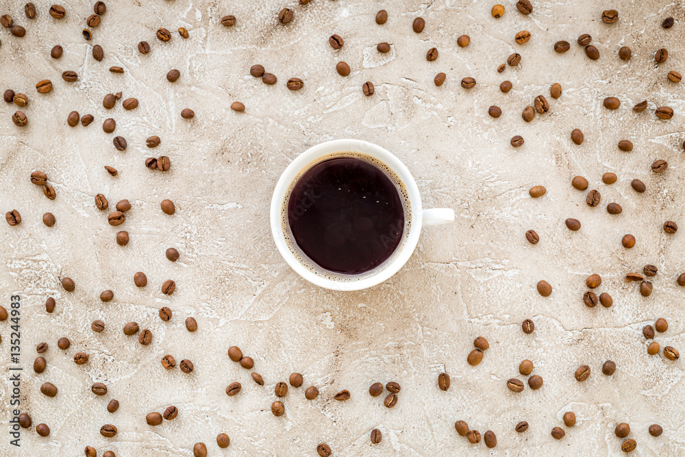 coffee beans on gray with coffe cup table top view