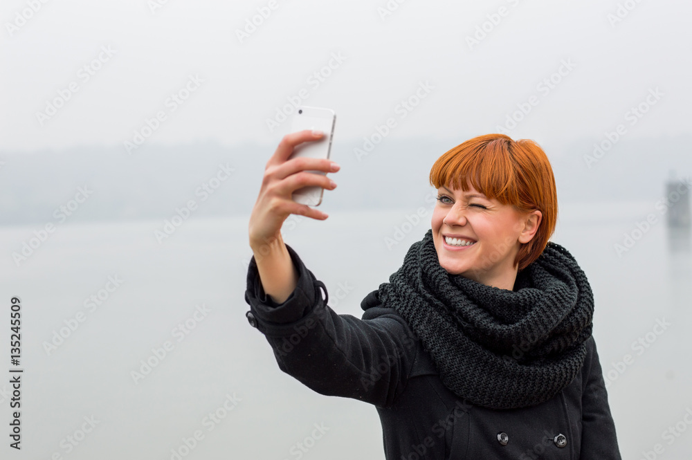 Pretty hipster girl taking selfie.