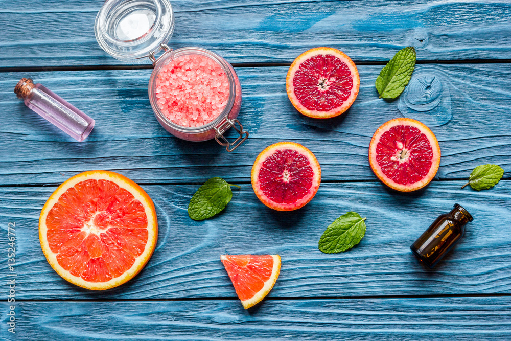 organic cosmetic with citrus on blue background top view