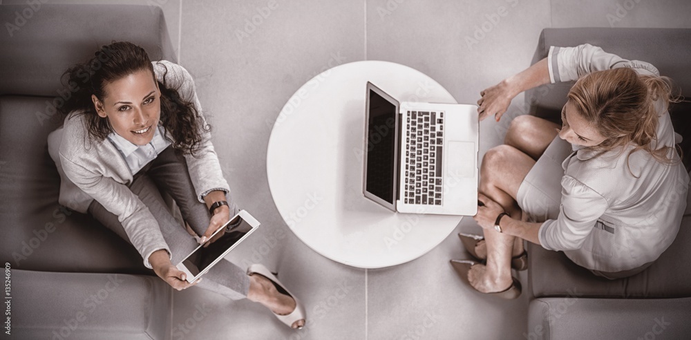 Businesswomen using laptop and digital tablet 