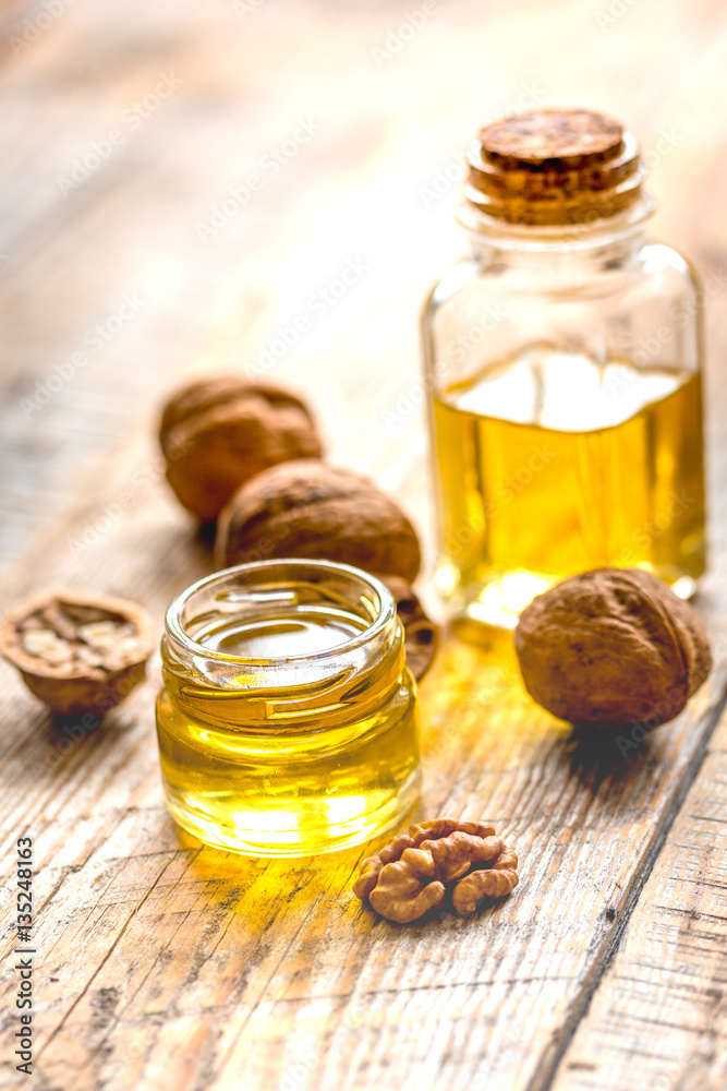 cosmetic and therapeutic walnut oil on wooden background