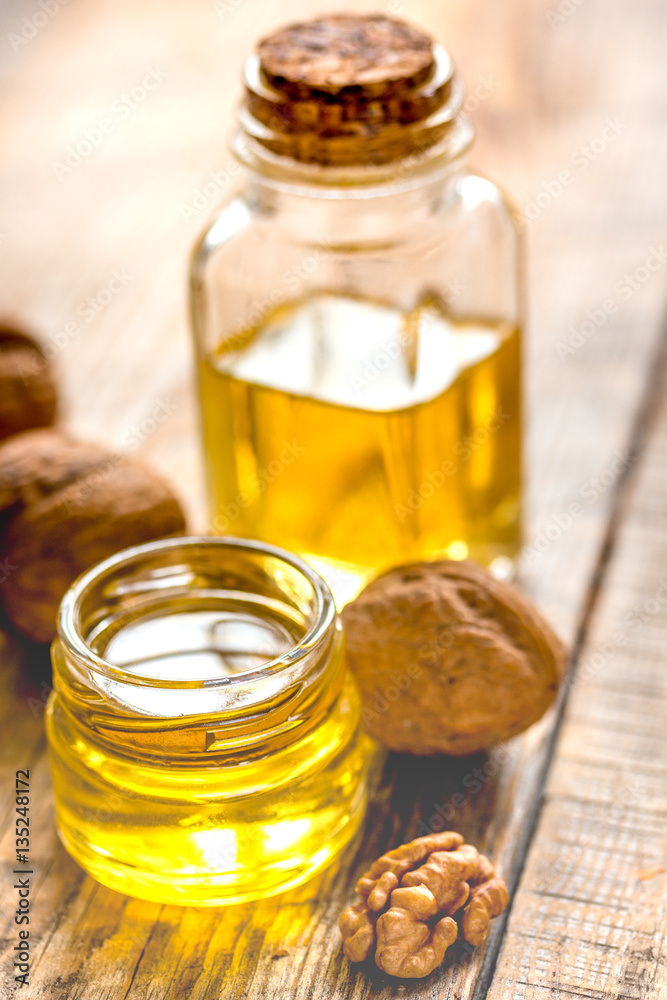 cosmetic and therapeutic walnut oil on wooden background