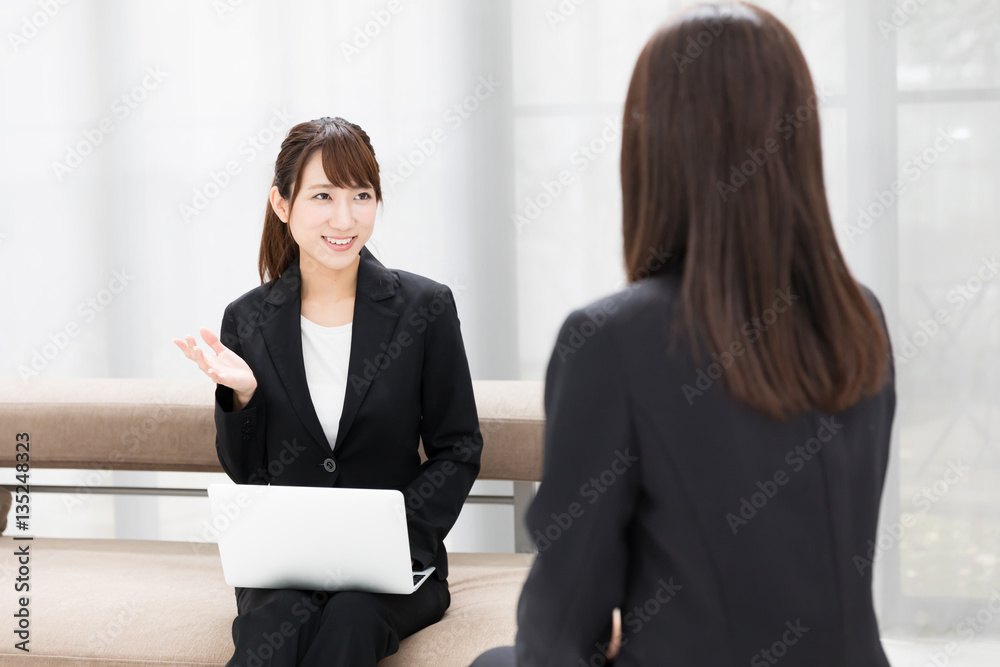 asian businesswomen talking in the room