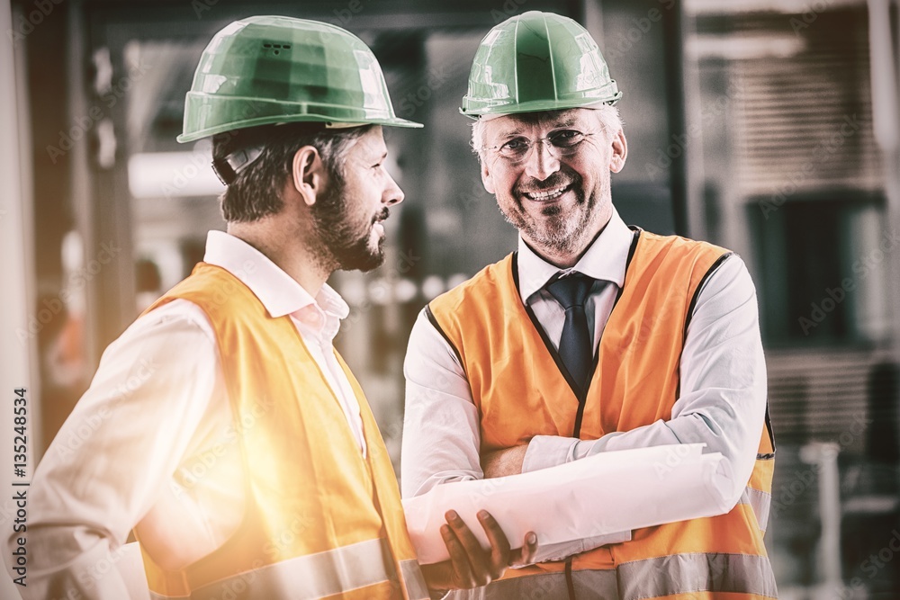 Portrait of architects standing by coworker