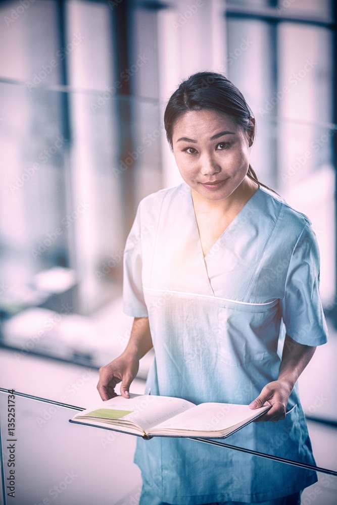 Nurse holding a diary in hospital