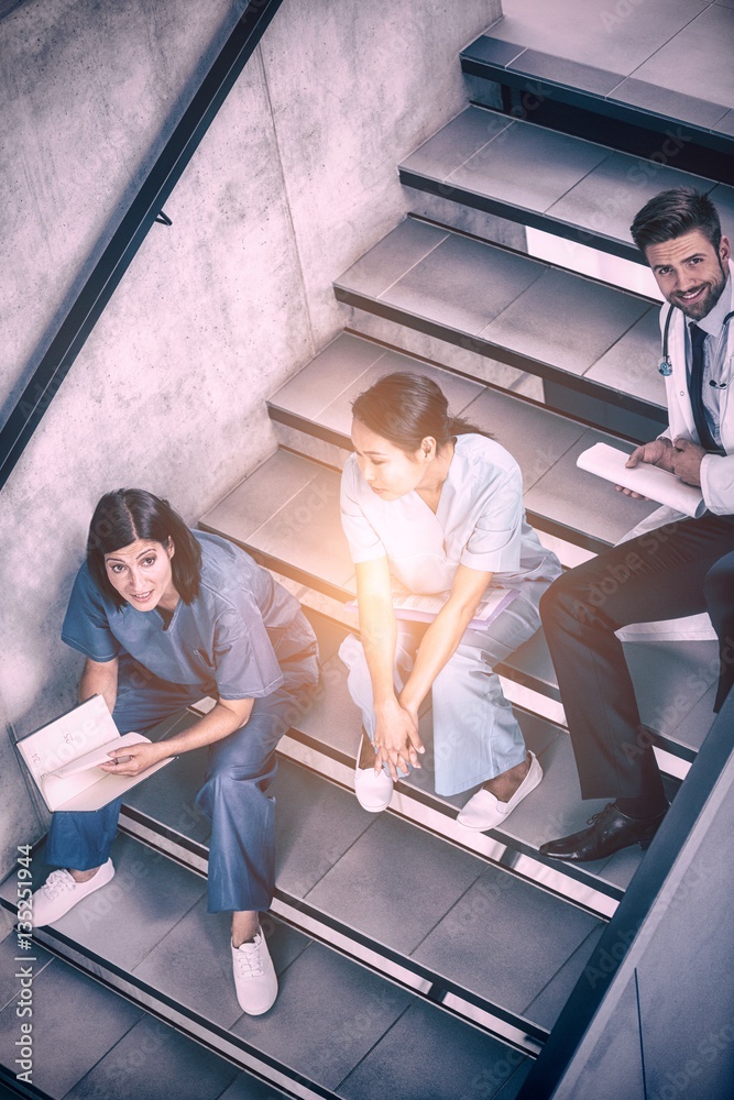 Nurses and doctor talking on stairs