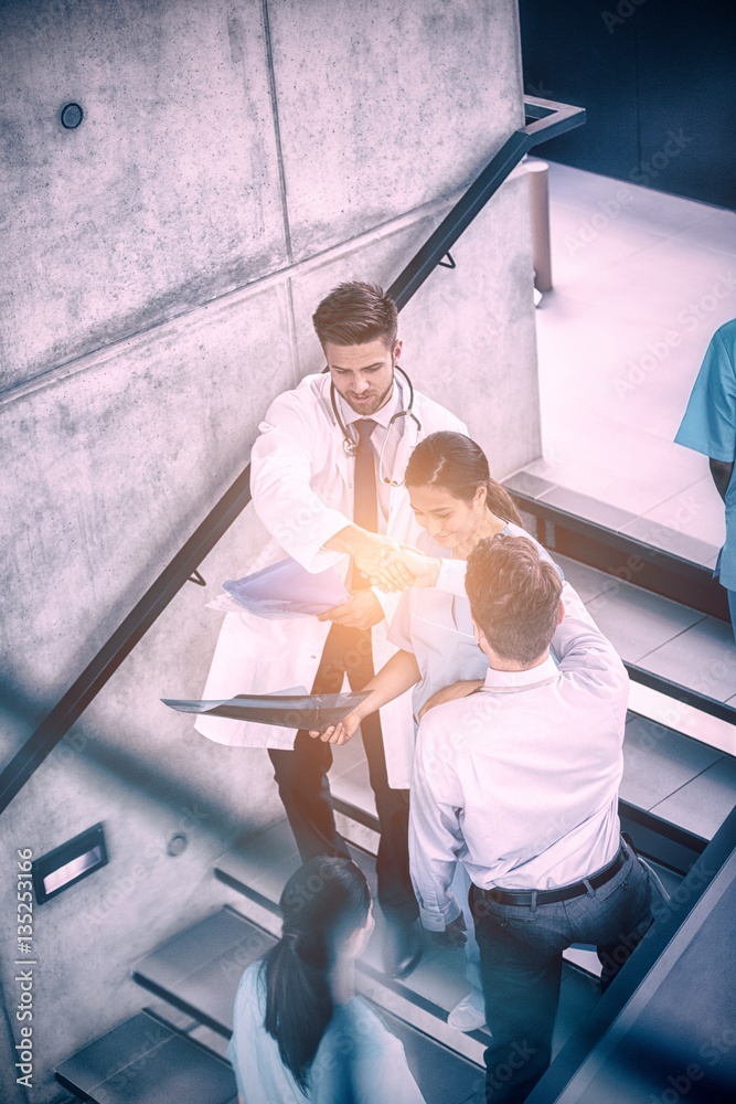 Doctor and nurse working while climbing down stairs