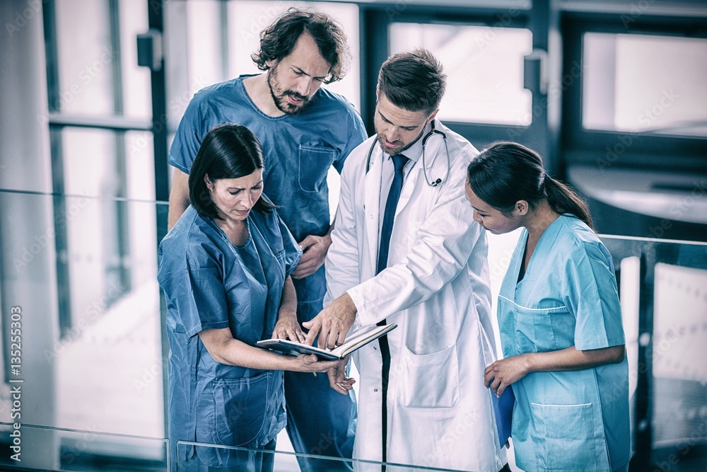 Surgeons discussing with nurse