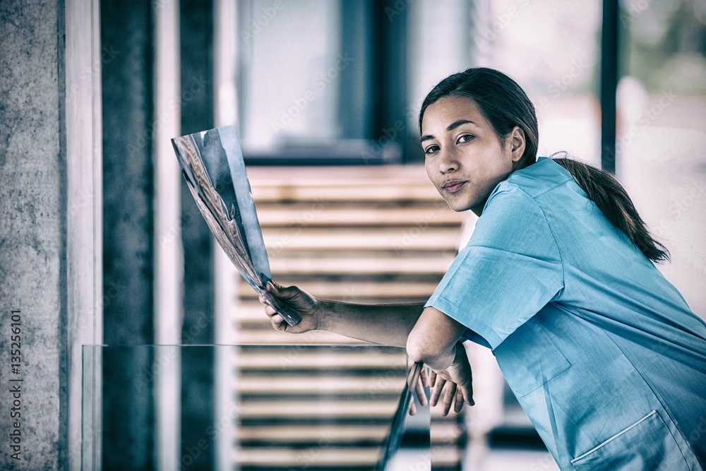 Portrait of nurse holding X-ray report