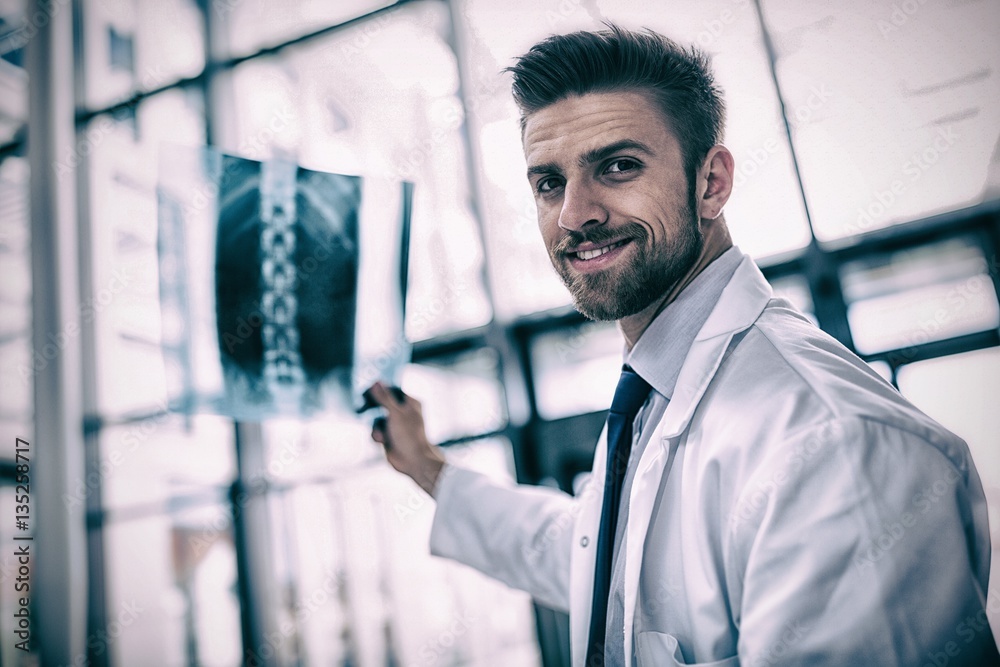 Portrait of doctor holding X-ray report