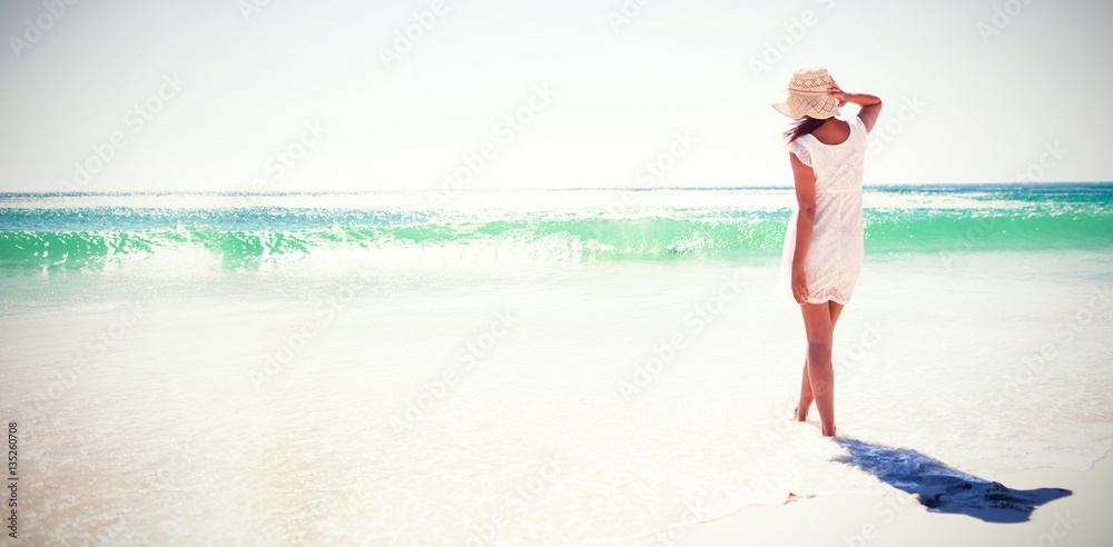 Woman in straw hat at beach