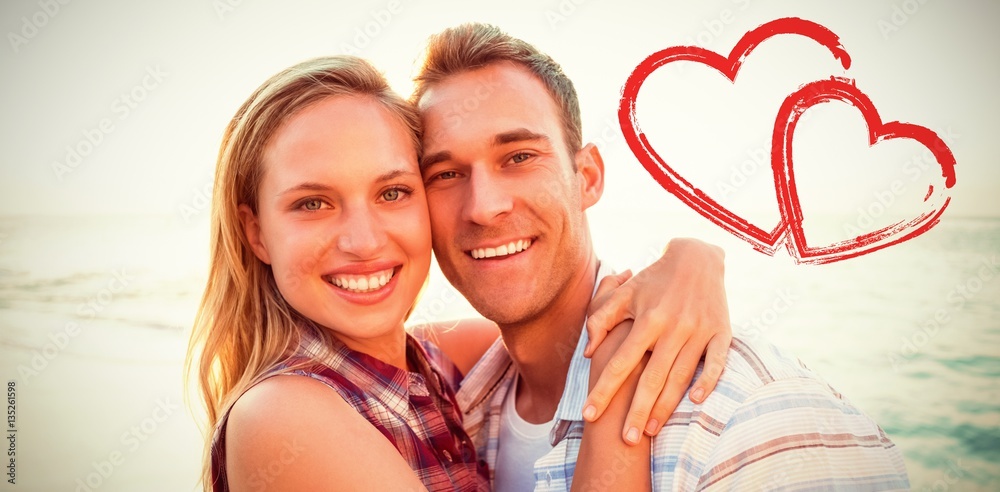 Composite image of couple embracing at beach