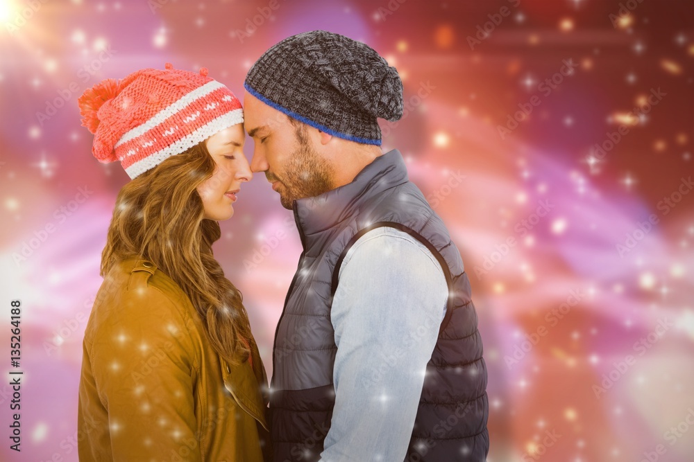 Composite image of happy young couple standing face to face