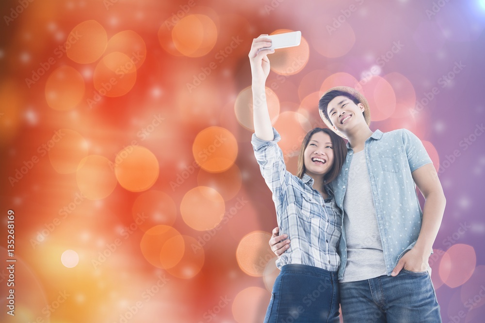 Composite image of happy young couple taking selfie