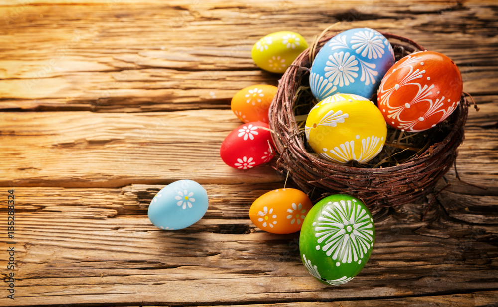 Easter eggs in basket placed on wooden board