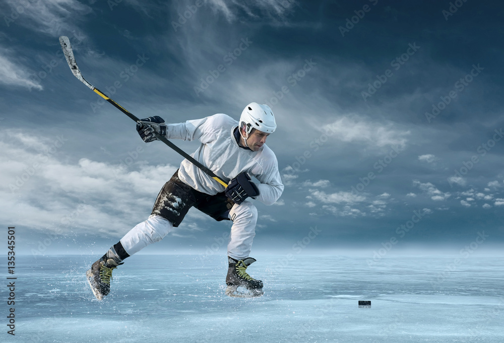 Ice hockey player in action outdoor around mountains