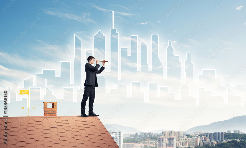 Engineer man standing on roof and looking in spyglass. Mixed med