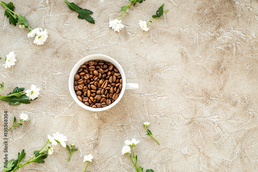 coffee beans on gray with coffe cup table top view