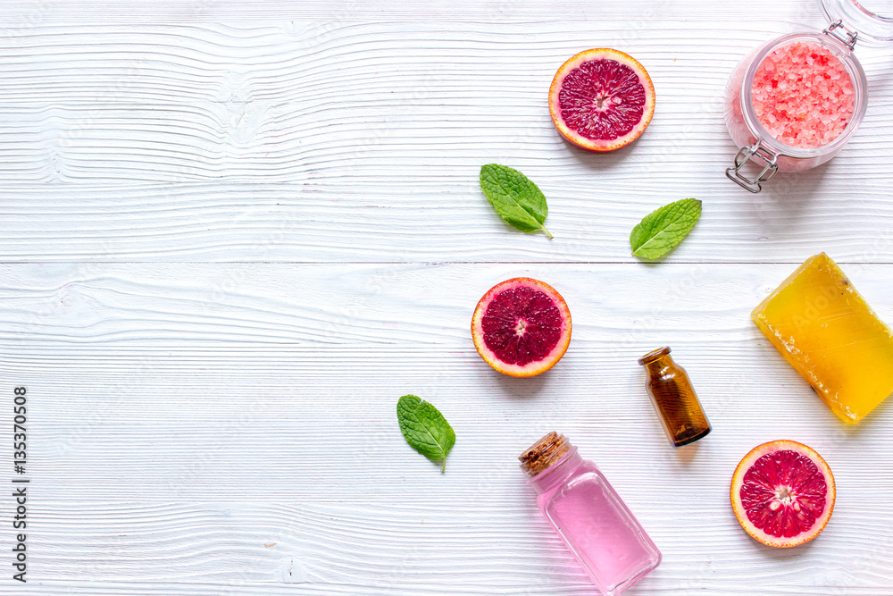 organic cosmetic with citrus on wooden background top view