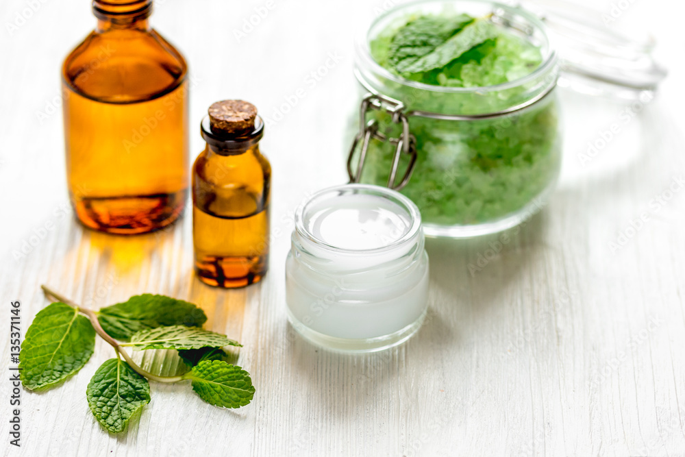 organic cosmetics with herbal extracts of mint on wooden background