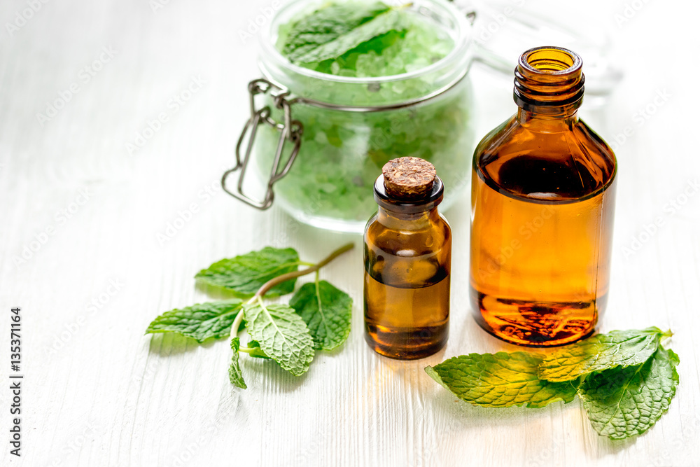 organic cosmetics with herbal extracts of mint on wooden background