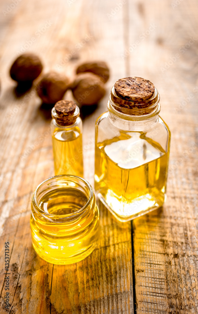 cosmetic and therapeutic walnut oil on wooden background