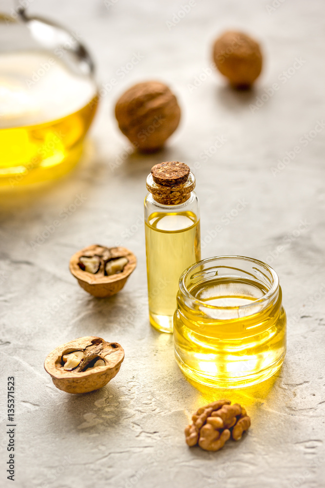 cosmetic and therapeutic walnut oil on gray background