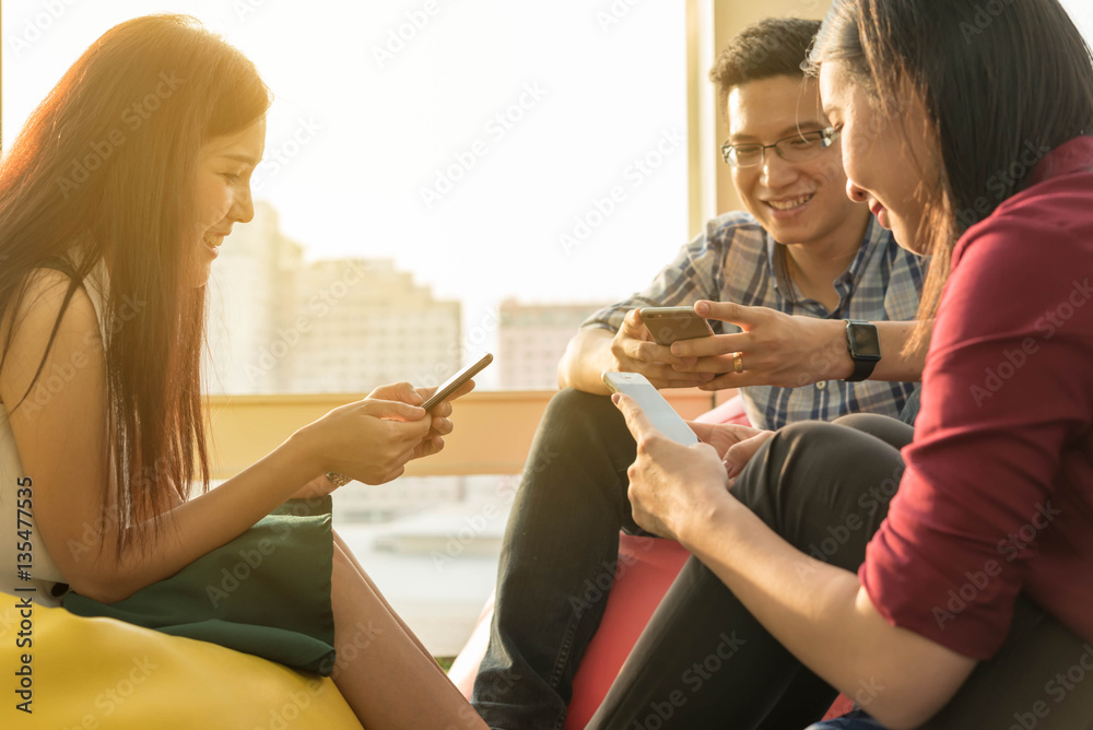 Hands of three person using smartphone together, IOT (internet o