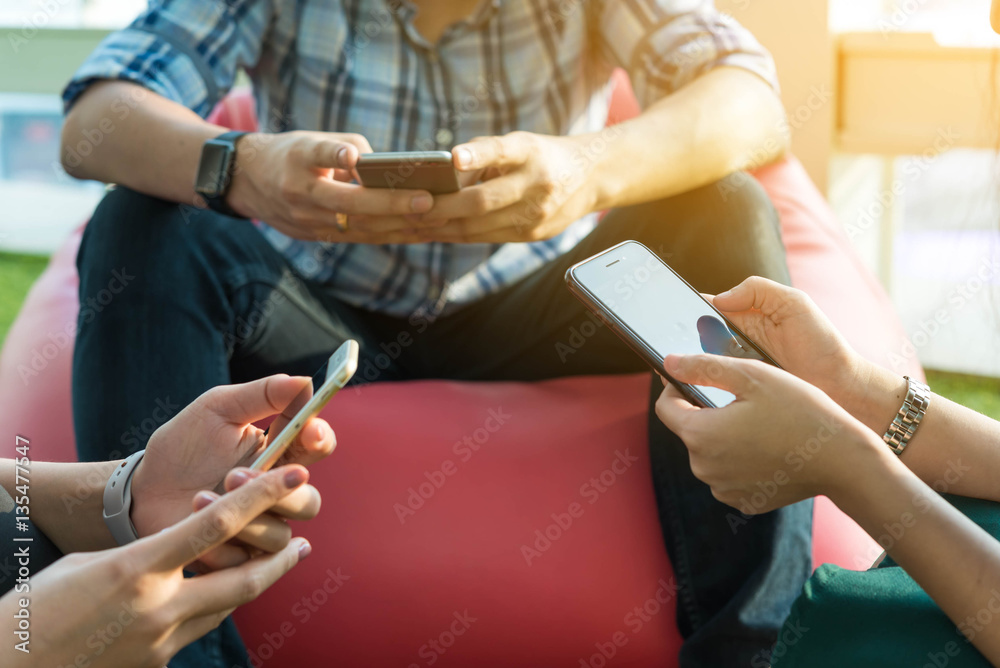 Hands of three person using smartphone together, IOT (internet o