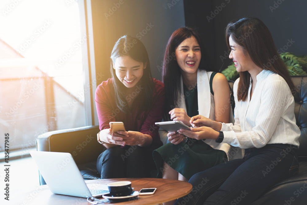 Group of friends meeting in a coffee shop chatting to each other