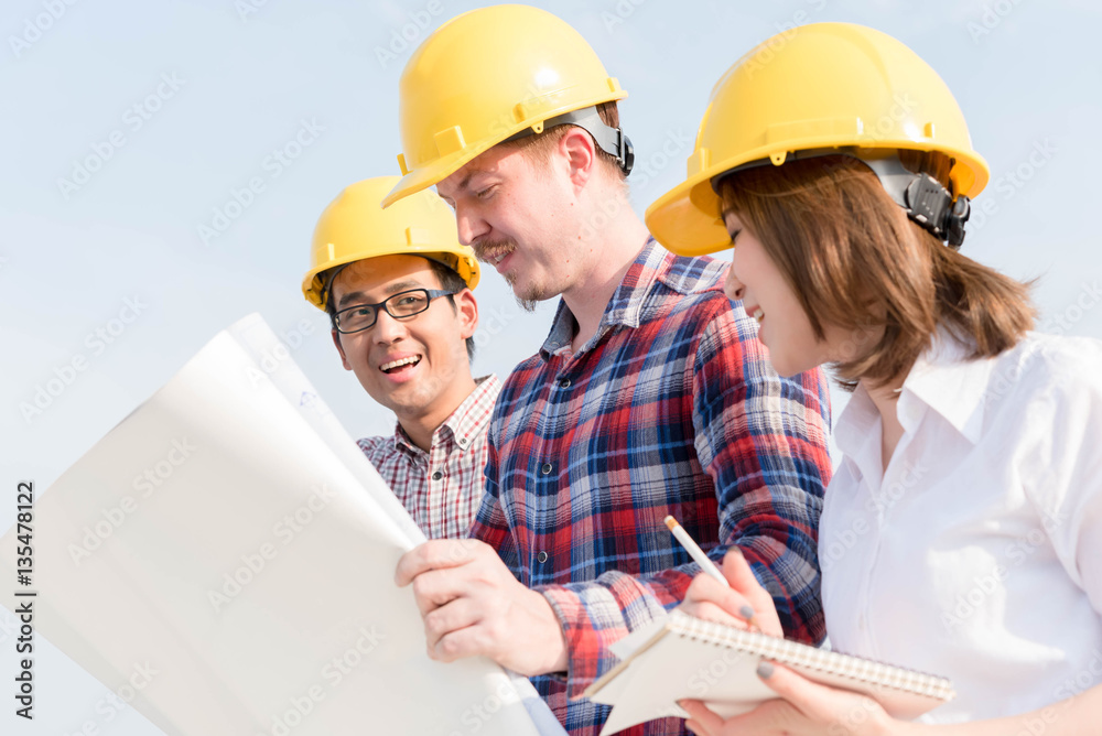 three construction engineers working outdoors in construction si