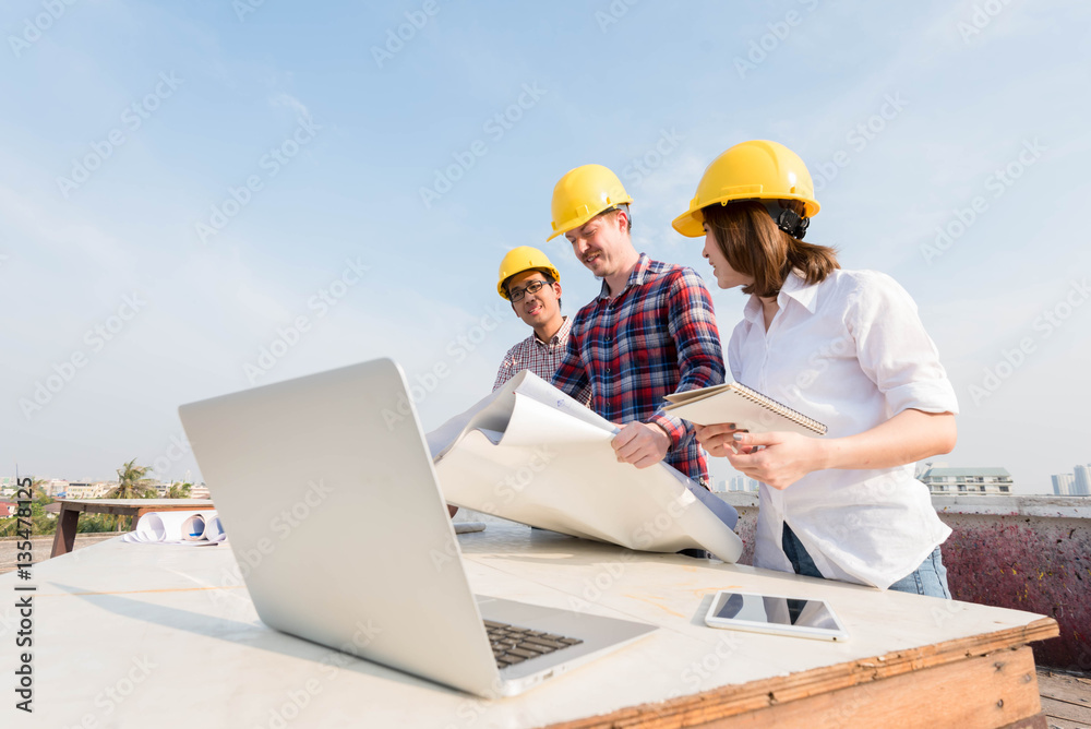 three construction engineers working outdoors in construction si