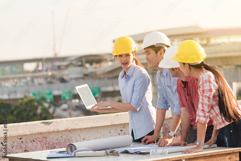 Four construction engineer working in construction site, constru