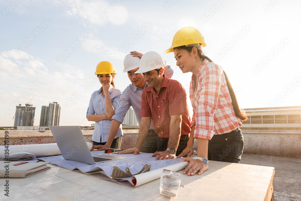 Four construction engineer working in construction site, constru