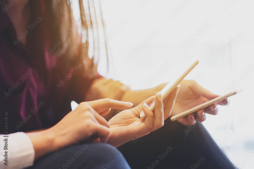 Two woman using smartphone sharing data, iot, internet of things