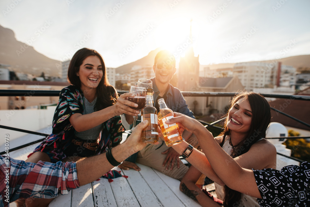 Happy people celebrating with drinks