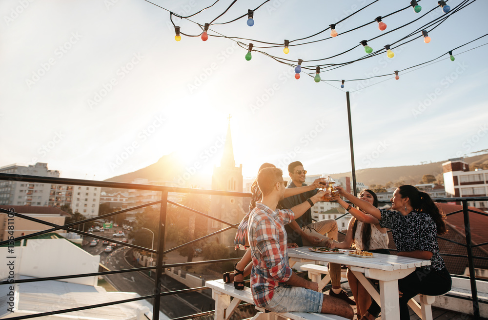 Young people toasting drinks at party