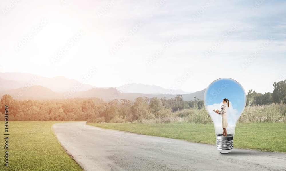 Businesswoman inside light bulb