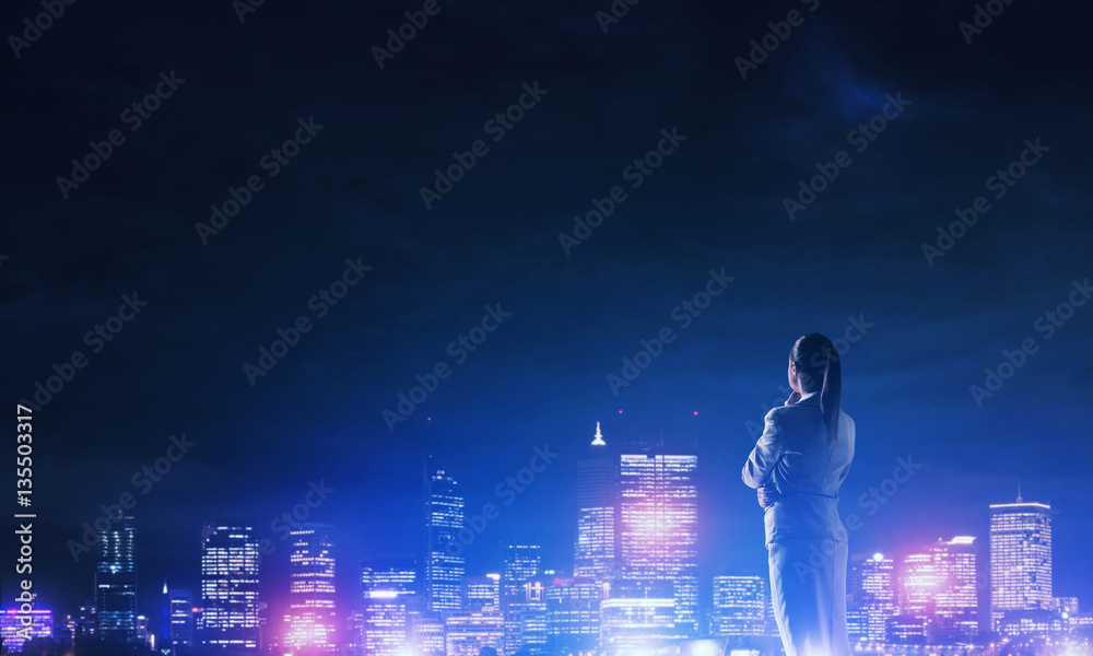 Woman looking at night city