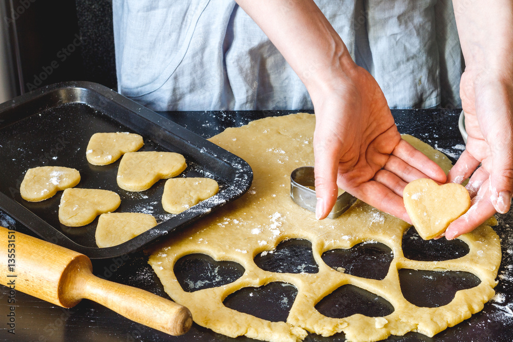 cooking homemade cookies with hands on dark background