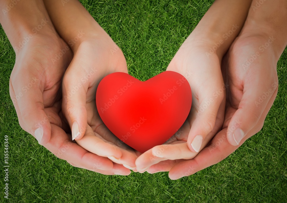 Couple holding heart shape in cupped hands