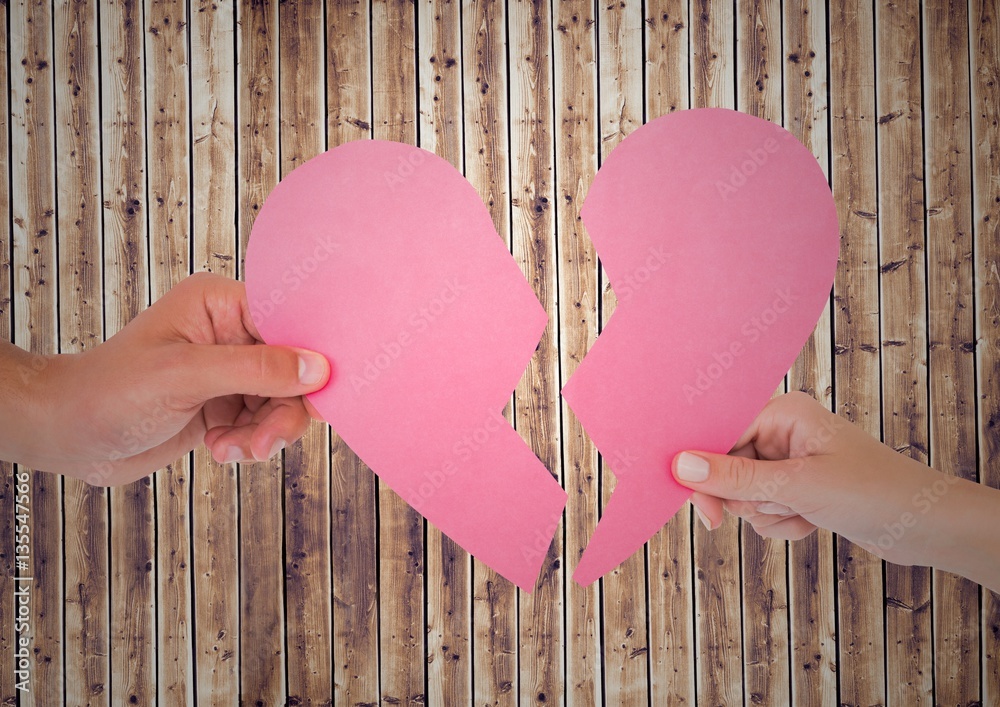 Hands of couple holding broken heart