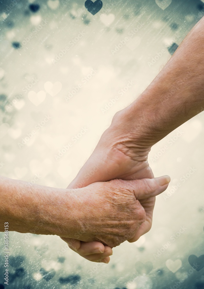 Hand of senior couple holding hands