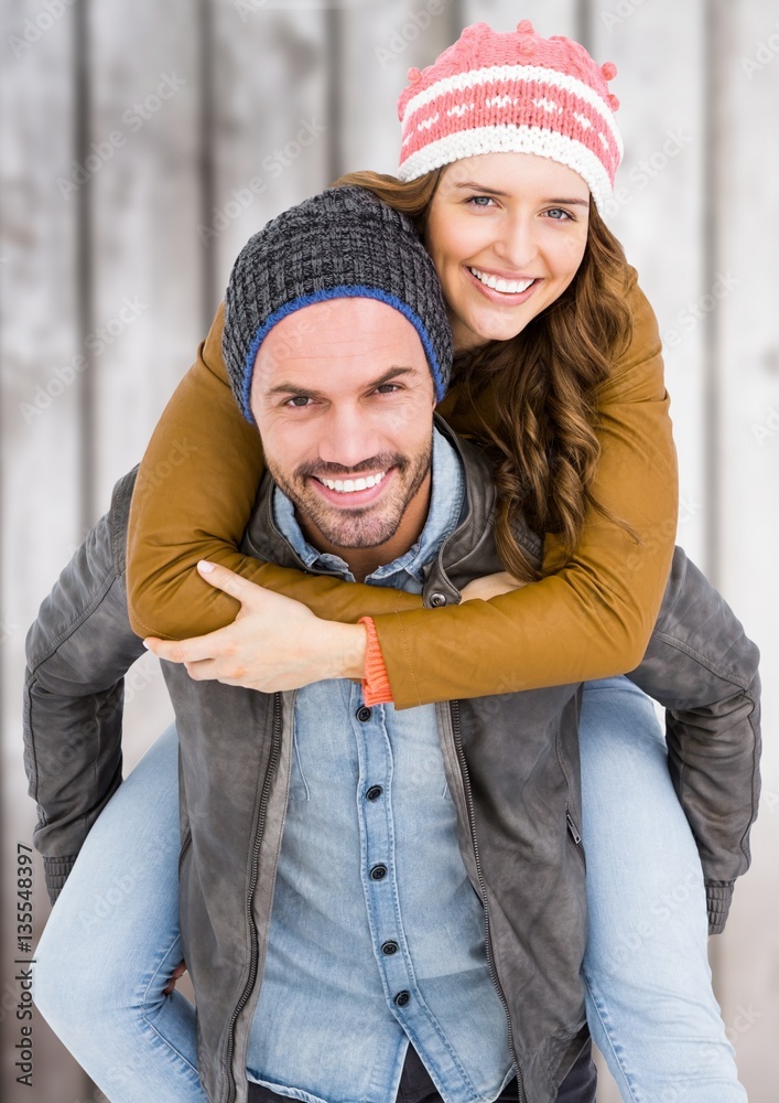 Man giving piggy back to woman