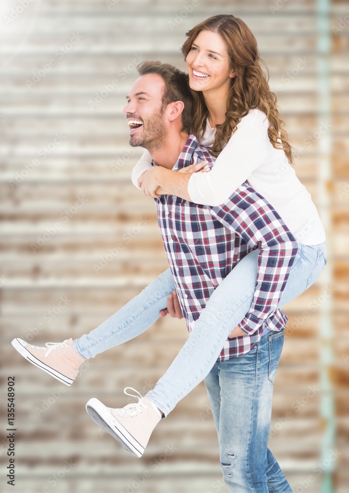 Happy man giving piggy back to woman