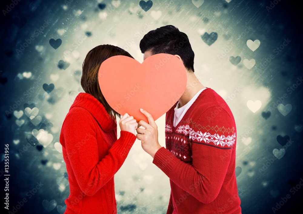 Romantic couple holding heart shape and kissing each other